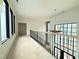 Hallway featuring many windows and wooden railing at 7013 Buckhead Dr, Raleigh, NC 27615