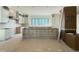 Expansive kitchen with white cabinetry, center island awaiting completion, and natural light filled at 7013 Buckhead Dr, Raleigh, NC 27615