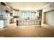 Spacious kitchen features a large island, marble countertops, and white cabinets at 7013 Buckhead Dr, Raleigh, NC 27615