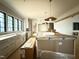 Bright kitchen with large island, white cabinets, stainless steel appliances and large windows at 7013 Buckhead Dr, Raleigh, NC 27615
