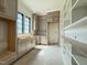 Well-lit kitchen showcasing modern gray cabinetry, large window, and open shelving with natural light at 7013 Buckhead Dr, Raleigh, NC 27615