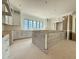 Spacious kitchen featuring white cabinets, large center island and large window bringing in natural light at 7013 Buckhead Dr, Raleigh, NC 27615