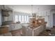 Spacious eat-in kitchen with light cabinetry, an oversized island, and stainless steel appliances at 7013 Buckhead Dr, Raleigh, NC 27615
