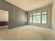 Gray living room showcasing elegant wall paneling, and large windows providing ample natural light at 7013 Buckhead Dr, Raleigh, NC 27615