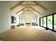 Open living space boasts soaring ceilings, exposed wood beams, and sliding glass doors at 7013 Buckhead Dr, Raleigh, NC 27615