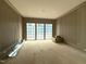 Bright living room featuring large windows and custom wall paneling at 7013 Buckhead Dr, Raleigh, NC 27615