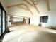 Open concept living area with exposed beams, large windows, and in progress kitchen at 7013 Buckhead Dr, Raleigh, NC 27615