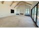 Open living room with wooden vaulted ceiling, a modern fireplace and sliding glass doors offering nice view at 7013 Buckhead Dr, Raleigh, NC 27615