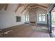 A spacious living room features wood beam architecture, a stone fireplace, and lots of natural light at 7013 Buckhead Dr, Raleigh, NC 27615