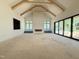 Bright living room featuring wooden vaulted ceiling, fireplace and sliding glass doors with view at 7013 Buckhead Dr, Raleigh, NC 27615