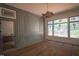 The office features custom wainscoting, a decorative chandelier, and large windows with a private view at 7013 Buckhead Dr, Raleigh, NC 27615