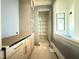 Walk-in pantry area featuring gray cabinets, counter space, brass hardware, and open shelving at 7013 Buckhead Dr, Raleigh, NC 27615