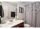 Well-lit bathroom with shower, vanity, and tasteful decor at 891 Cupola Dr, Raleigh, NC 27603