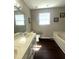 Bathroom with double sinks, a window, and a tub creating a spa-like atmosphere at 9201 Sayornis Ct, Raleigh, NC 27615