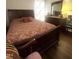 Cozy bedroom featuring hardwood floors, a large bed, and natural light at 9201 Sayornis Ct, Raleigh, NC 27615