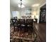 Cozy dining room with a large wooden table and a colorful rug at 9201 Sayornis Ct, Raleigh, NC 27615