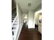 Hallway with hardwood floors leading to the kitchen and living area at 9201 Sayornis Ct, Raleigh, NC 27615