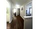 Spacious hallway with hardwood floors and neutral walls, providing access to bedrooms and bathrooms at 9201 Sayornis Ct, Raleigh, NC 27615