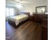 Comfortable bedroom featuring hardwood floors, a large window, and generous closet space at 9201 Sayornis Ct, Raleigh, NC 27615