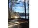 Scenic walking path through the woods near a serene lake, perfect for nature lovers at 9201 Sayornis Ct, Raleigh, NC 27615