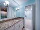 Bathroom with granite countertop, white cabinets and walk-in closet at 1009 Deboy St, Raleigh, NC 27606