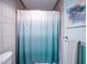 Clean bathroom with a teal shower curtain and light blue walls at 1009 Deboy St, Raleigh, NC 27606