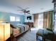 Serene bedroom with light blue walls, hardwood floors, and access to a deck at 1009 Deboy St, Raleigh, NC 27606
