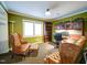 Home office with built-in shelving, hardwood floors, and comfortable leather chairs at 1009 Deboy St, Raleigh, NC 27606