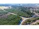 Aerial view of property with road access and surrounding trees at 1100 Ben Smith Road Rd, Siler City, NC 27344