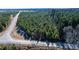Aerial view of property showing road access and wooded area at 1100 Ben Smith Road Rd, Siler City, NC 27344