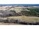 Aerial view of property showcasing fields and trees at 1100 Ben Smith Road Rd, Siler City, NC 27344