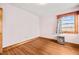 Small bedroom with hardwood floors and a space heater at 1100 Ben Smith Road Rd, Siler City, NC 27344