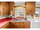 Kitchen sink and countertop detail with wood cabinets at 1100 Ben Smith Road Rd, Siler City, NC 27344