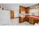 Kitchen with wood cabinets, red countertops, and a chandelier at 1100 Ben Smith Road Rd, Siler City, NC 27344