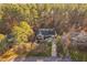 Aerial view of a home nestled in a tranquil, wooded setting at 1210 Huntsman Dr, Durham, NC 27713