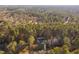 Aerial view of a home surrounded by a lush, green forest at 1210 Huntsman Dr, Durham, NC 27713