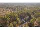 Aerial view of a home surrounded by trees in a residential neighborhood at 1210 Huntsman Dr, Durham, NC 27713