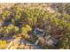 Aerial view of a home surrounded by trees in a residential neighborhood at 1210 Huntsman Dr, Durham, NC 27713