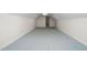 Spacious attic with new blue carpet, pristine white walls and a door to another room, showing potential for expansion at 1210 Huntsman Dr, Durham, NC 27713