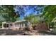 Rear exterior view showcasing the patio area, brick and siding finishes, as well as access to the private backyard space at 1210 Huntsman Dr, Durham, NC 27713