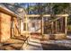 Backyard view shows patio and pergola structure, with a brick facade and lawn space, great for outdoor activities at 1210 Huntsman Dr, Durham, NC 27713