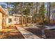 A wooden deck sits off the home with a gravel path and wooden bridge meandering to the back of the large yard at 1210 Huntsman Dr, Durham, NC 27713