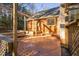 Backyard showing a quaint brick patio area, a pergola, and string lights, perfect for outdoor enjoyment at 1210 Huntsman Dr, Durham, NC 27713