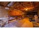 Basement area features a workbench, exposed ceiling, and a walkout, creating a space for hobbies and storage at 1210 Huntsman Dr, Durham, NC 27713