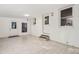 Finished basement with painted brick walls, tile floors, and access to the exterior at 1210 Huntsman Dr, Durham, NC 27713
