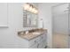 Bathroom featuring granite countertop, vanity with lighting, and towel rack at 1210 Huntsman Dr, Durham, NC 27713