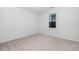A bright bedroom with neutral carpet and a window providing natural light at 1210 Huntsman Dr, Durham, NC 27713