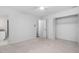 Bedroom featuring neutral carpet, with access to bathroom and closet at 1210 Huntsman Dr, Durham, NC 27713