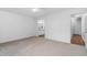 A spacious bedroom with neutral carpet, ceiling fan, and an attached bathroom at 1210 Huntsman Dr, Durham, NC 27713