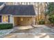 Attached carport with a covered area, featuring exterior doors and ample parking space at 1210 Huntsman Dr, Durham, NC 27713